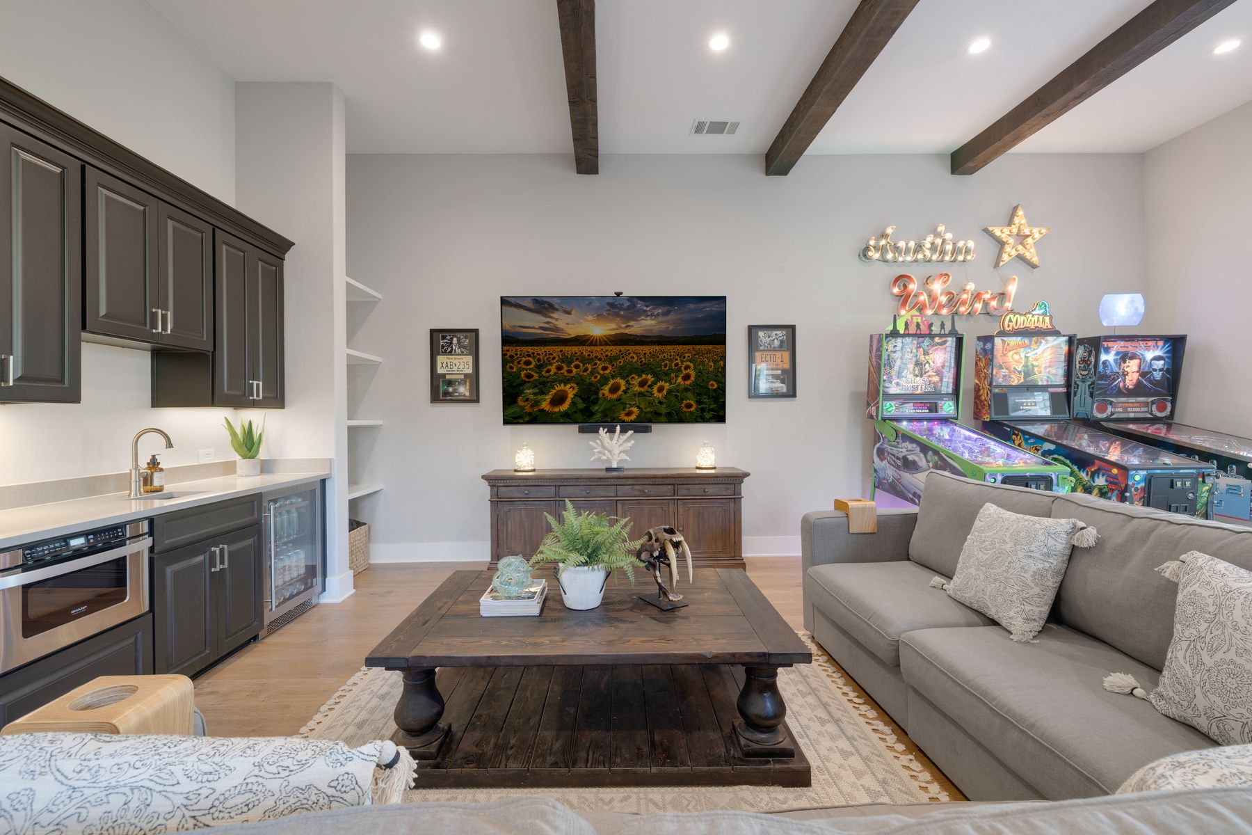 496 Primo Fiore Terrace Austin, TX 78738 - Photo 29 of 40 a living room with furniture a flat screen tv and kitchen view
