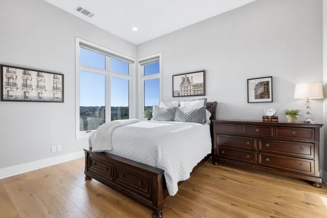 a bedroom with a bed and a night stand