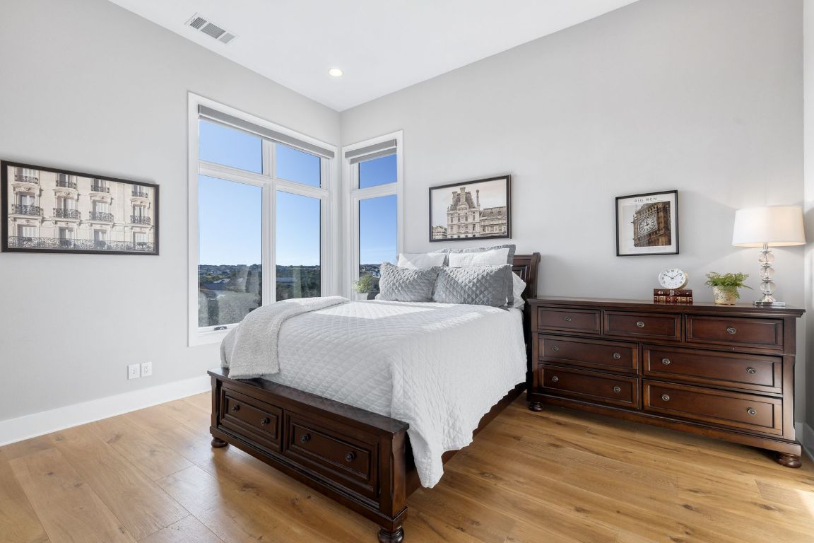 496 Primo Fiore Terrace Austin, TX 78738 - Photo 30 of 40 a bedroom with a bed and a night stand