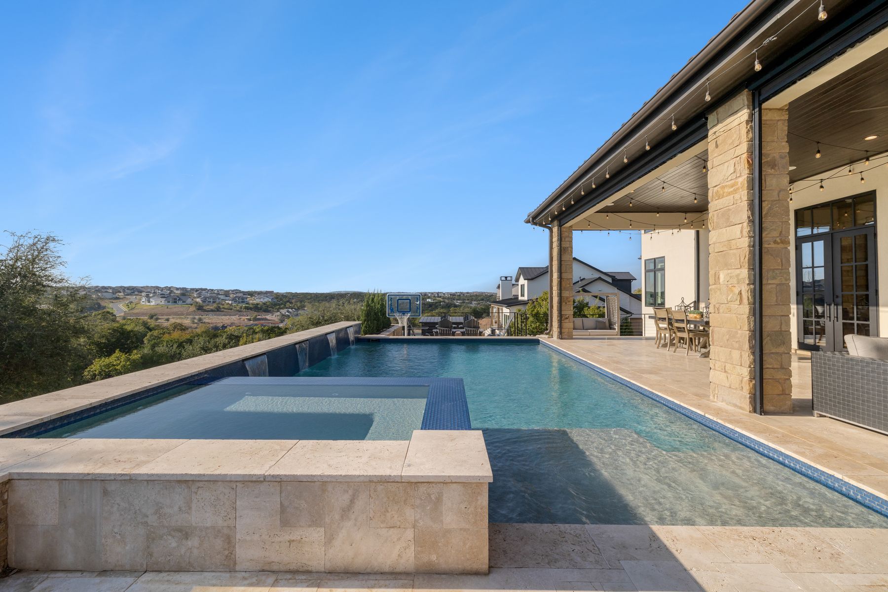 496 Primo Fiore Terrace Austin, TX 78738 - Photo 3 of 40 View of pool featuring a patio, a pool with connected hot tub, and outdoor dining space