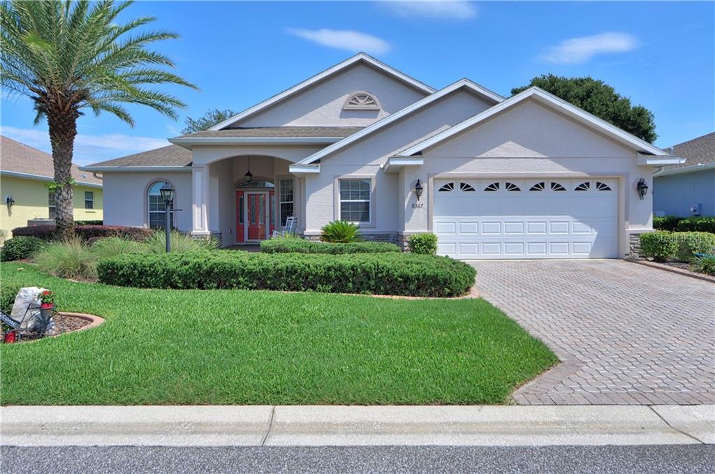 8367 Southwest 84th Loop Ocala, FL 34481 - Photo 1 of 1 a front view of a house with a yard and garage