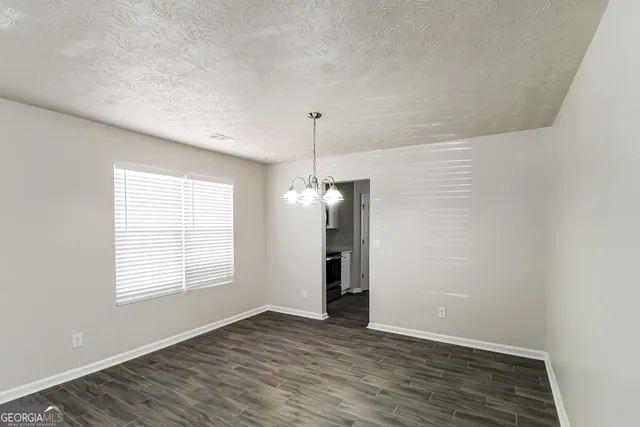 an empty room with windows and a fireplace