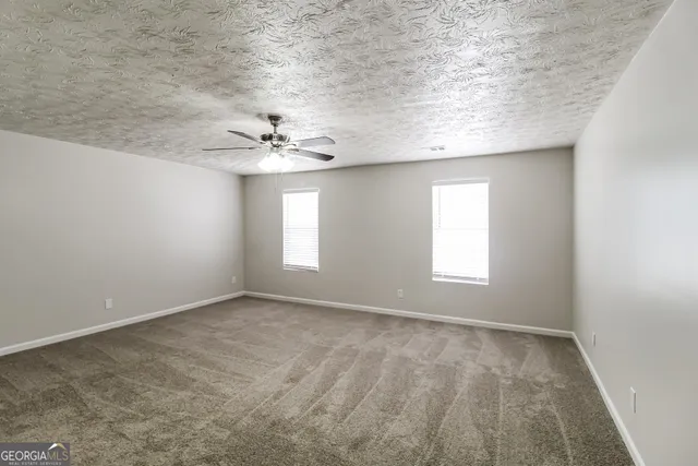 a view of a chandelier fan in big room