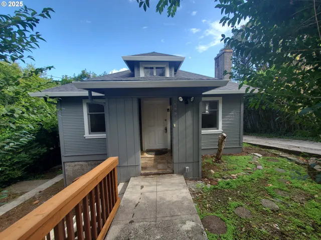 a view of a pathway with a house in the background