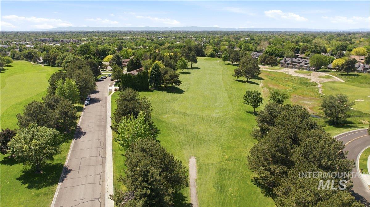 599 Pebble Beach Way Eagle, ID 83616 - Photo 43 of 44 Expansive green spaces featuring mature trees, paved roadways, and a golf course environment