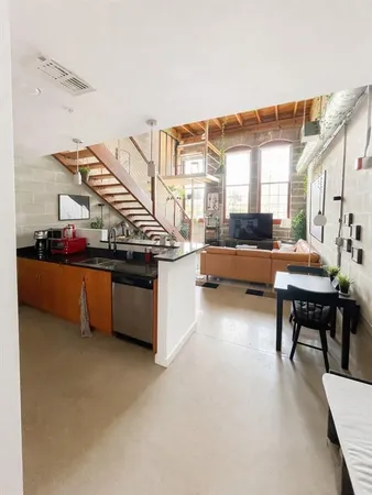 a kitchen with stainless steel appliances granite countertop a sink refrigerator and microwave