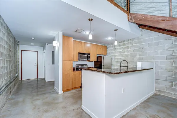 a kitchen with stainless steel appliances granite countertop a sink stove and microwave