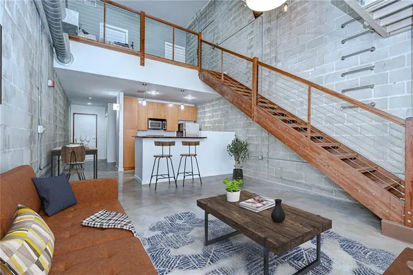 a living room with furniture windows and a flat screen tv