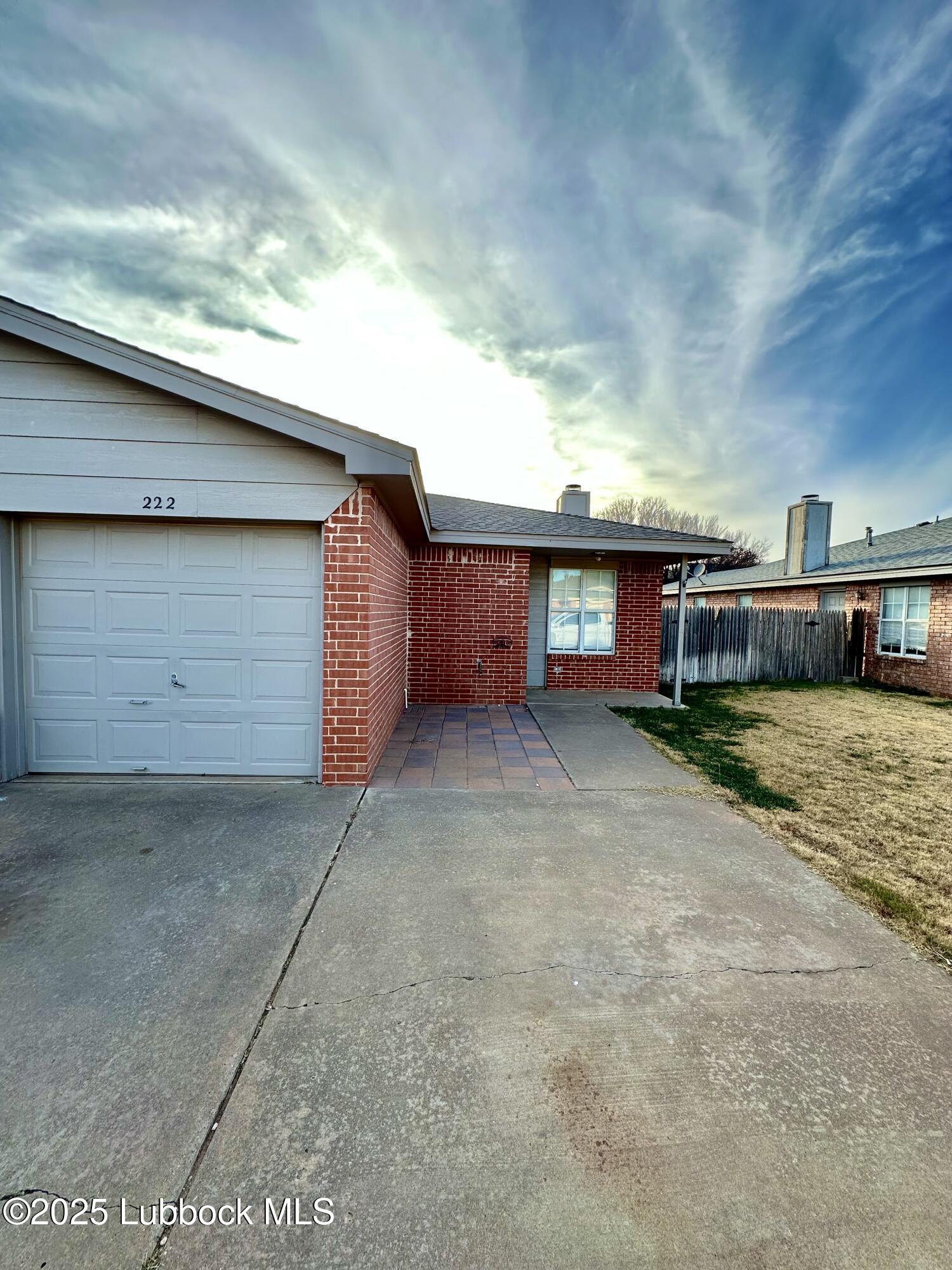 222 Grover Avenue Lubbock, TX 79416 - Photo 1 of 14 a view of a house with a yard and garage