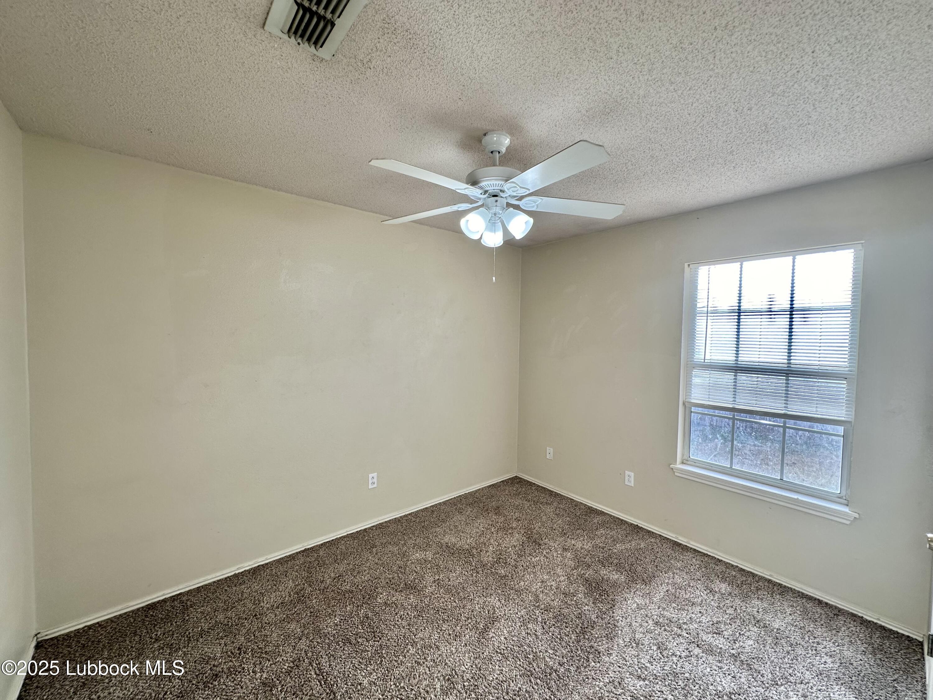 222 Grover Avenue Lubbock, TX 79416 - Photo 9 of 14 an empty room with a window