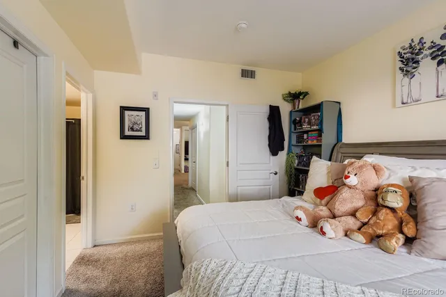 a bedroom with a bed and a painting on the wall