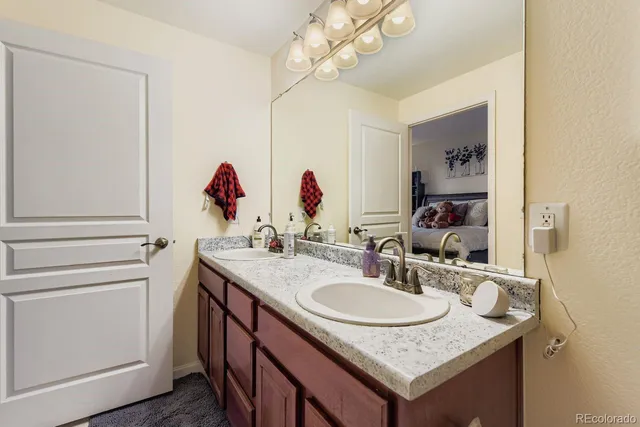 a bathroom with a granite countertop sink a mirror and a sink