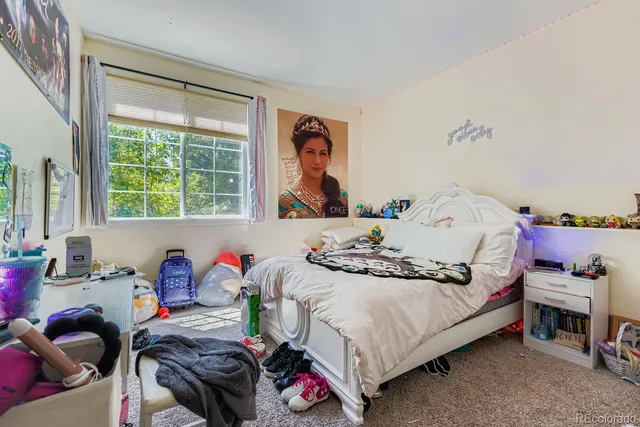 a bedroom with furniture and a window