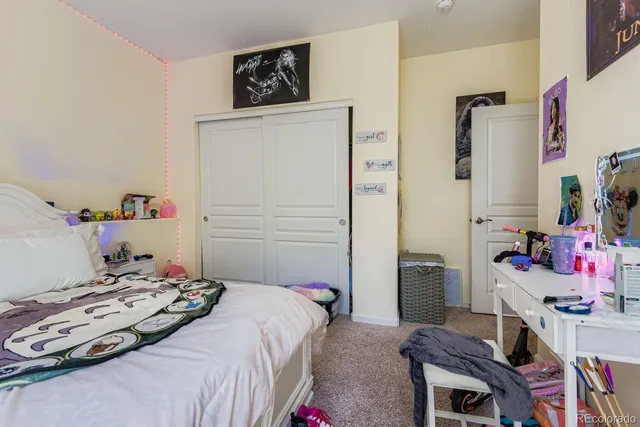 a bedroom that has a bed and a desk in it