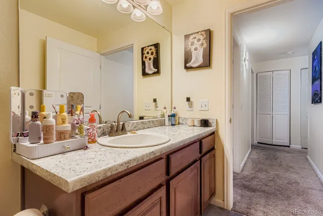 a bathroom with a granite countertop sink and a mirror
