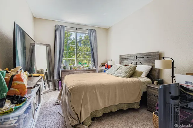 a bed sitting in a bedroom next to a window