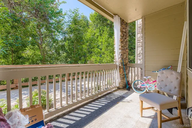 a porch with furniture and garden view