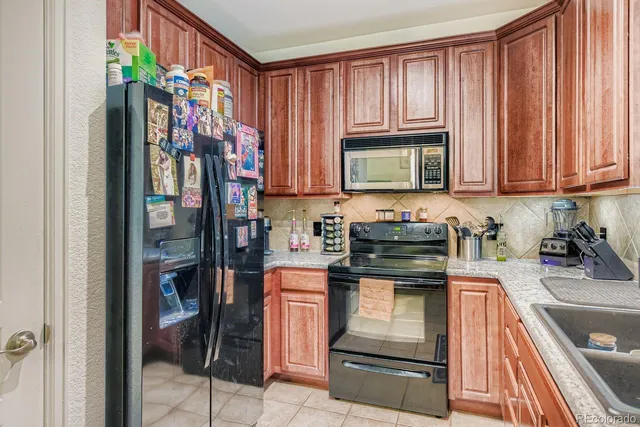 a kitchen with a stove and a refrigerator