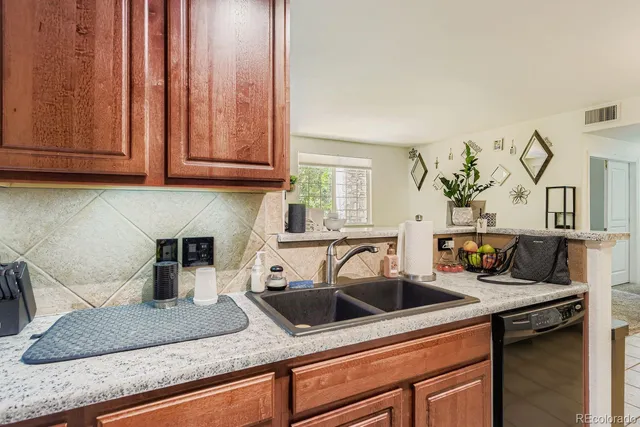a kitchen with stainless steel appliances granite countertop a sink a stove and cabinets