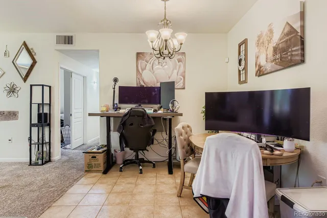a view of a workspace with furniture and a flat screen tv