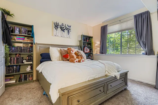 a bedroom with a bed and a book shelf