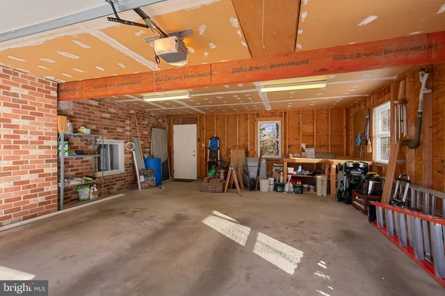 a view of a room with wooden floor and a potted plant