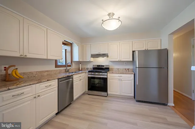 a view of a kitchen with a sink and microwave