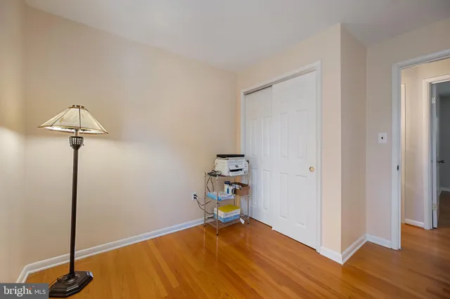 an empty room with wooden floor and closet