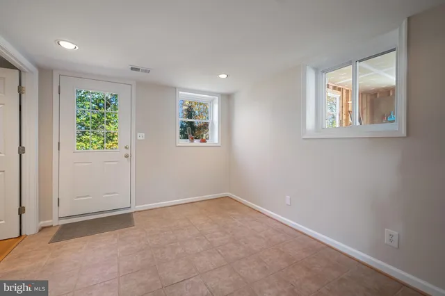 an empty room with windows and closet