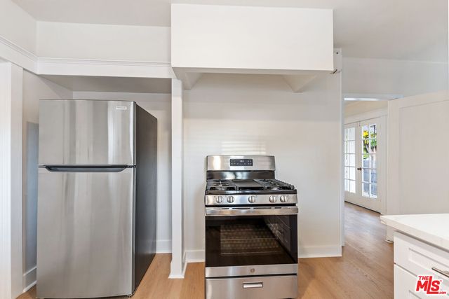 a kitchen with a stove and a refrigerator