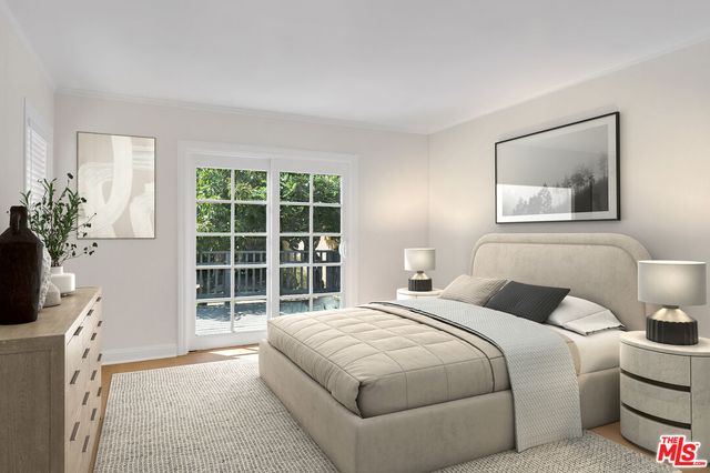 a bedroom with a large bed and a potted plant