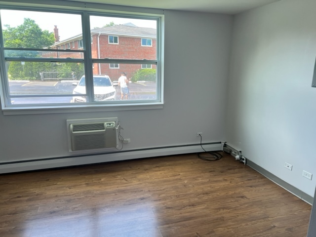 720 Crescent Street, Unit 111 Wheaton, IL 60187 - Photo 3 of 4 a view of a kitchen with wooden floor and a window