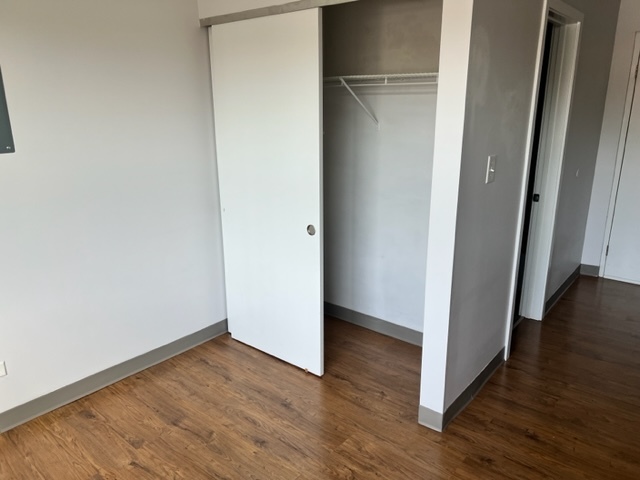 720 Crescent Street, Unit 111 Wheaton, IL 60187 - Photo 4 of 4 a view of a hallway with wooden floor