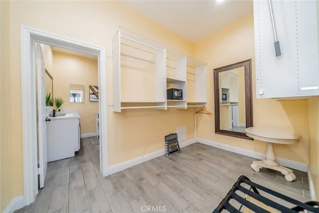 a view of a kitchen with wooden floor and a sink