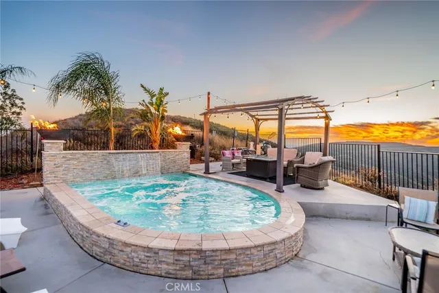 a view of a swimming pool with a table and chairs