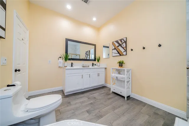 a bedroom with furniture and a flat screen tv