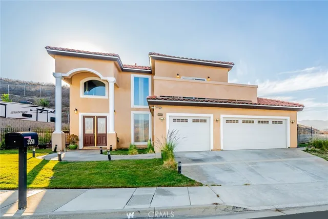 a front view of a house with a yard and garage