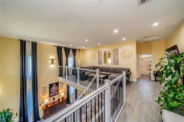 a view of a white house with a yard and plants