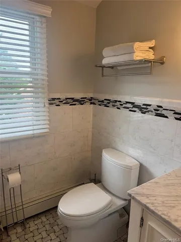 a white toilet sitting next to a bathroom sink