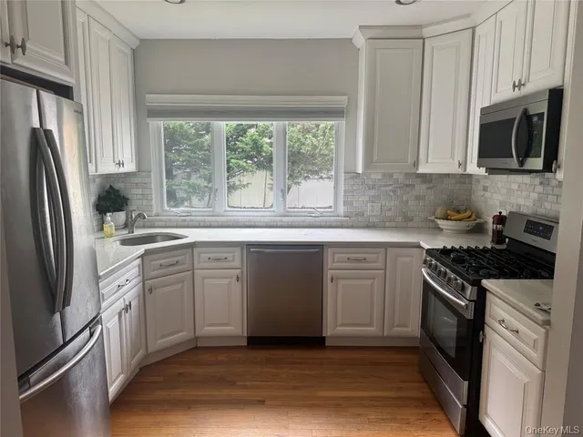 a kitchen with a stove a sink and a microwave