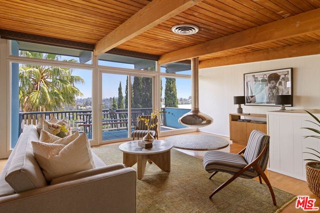 a outdoor living space with furniture and a black umbrella