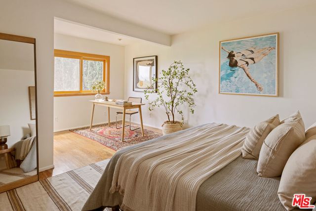 a bedroom with a bed and glass windows