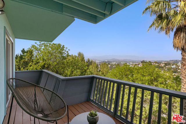 a view of a balcony with chairs