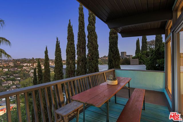 a view of a balcony with a table and chairs