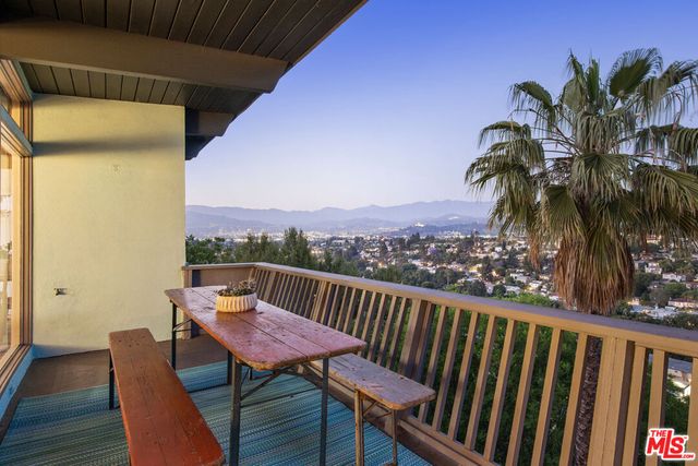 a view of balcony with furniture and city view