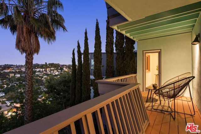 view of house with a yard and potted plants