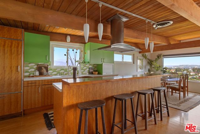 a dining table chairs and a umbrella