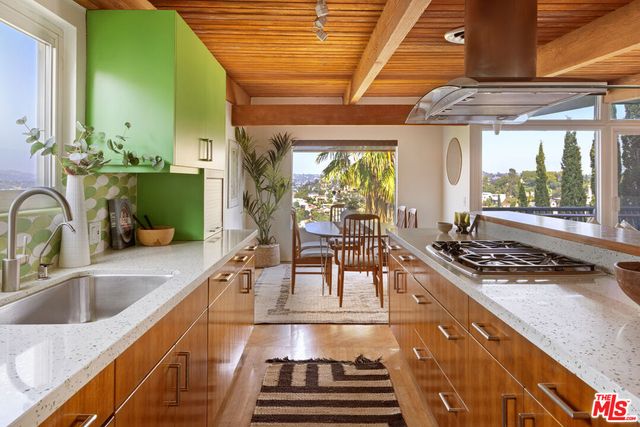a kitchen with a stove a sink and cabinets