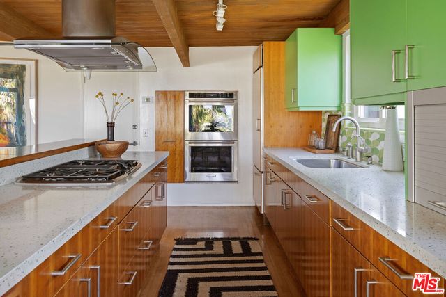a kitchen with wooden cabinets and a stove top oven