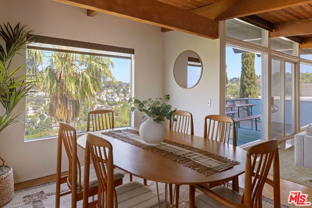 a view of a dining room with furniture window and outside view